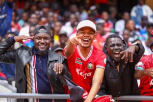 Fans celebrating Harambee Stars win at Kasarani Stadium.
